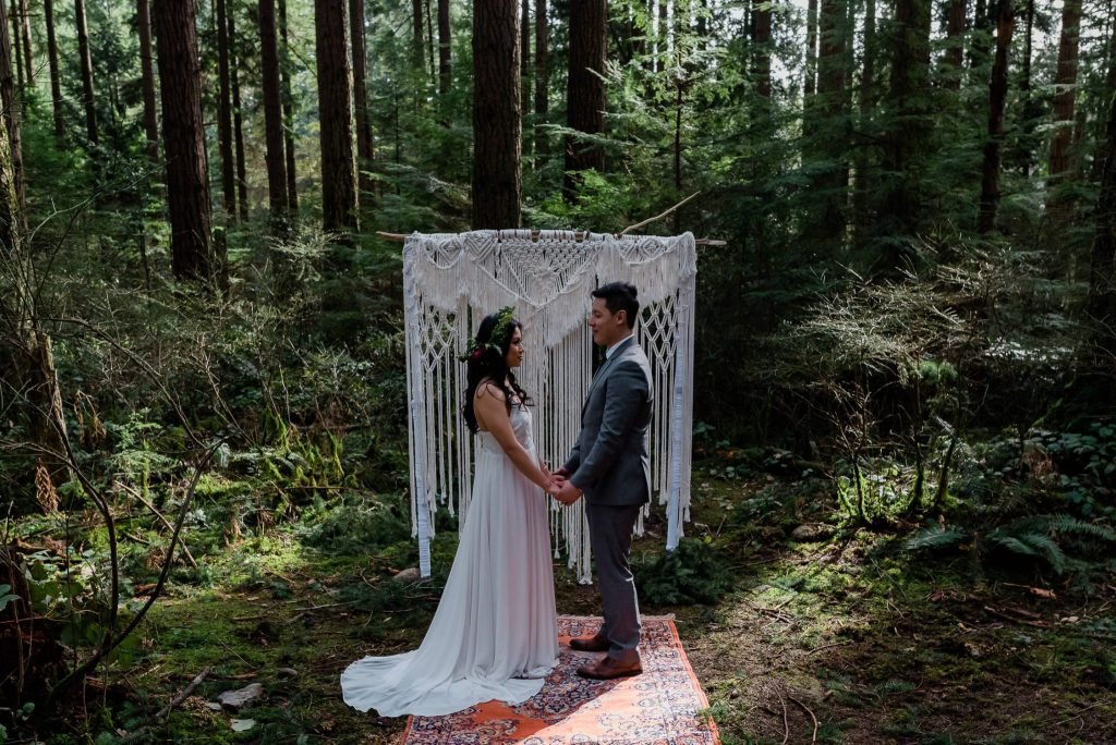 Boho inspired couple in their forest elopement.