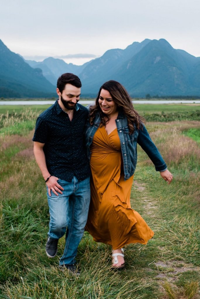 Couple in front of mountains during engagement session at Pitt Lake, BC. 