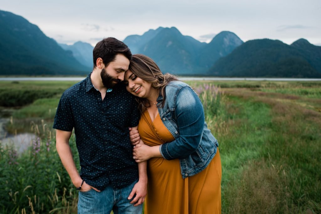 Couple in front of mountains during engagement session at Pitt Lake, BC. 