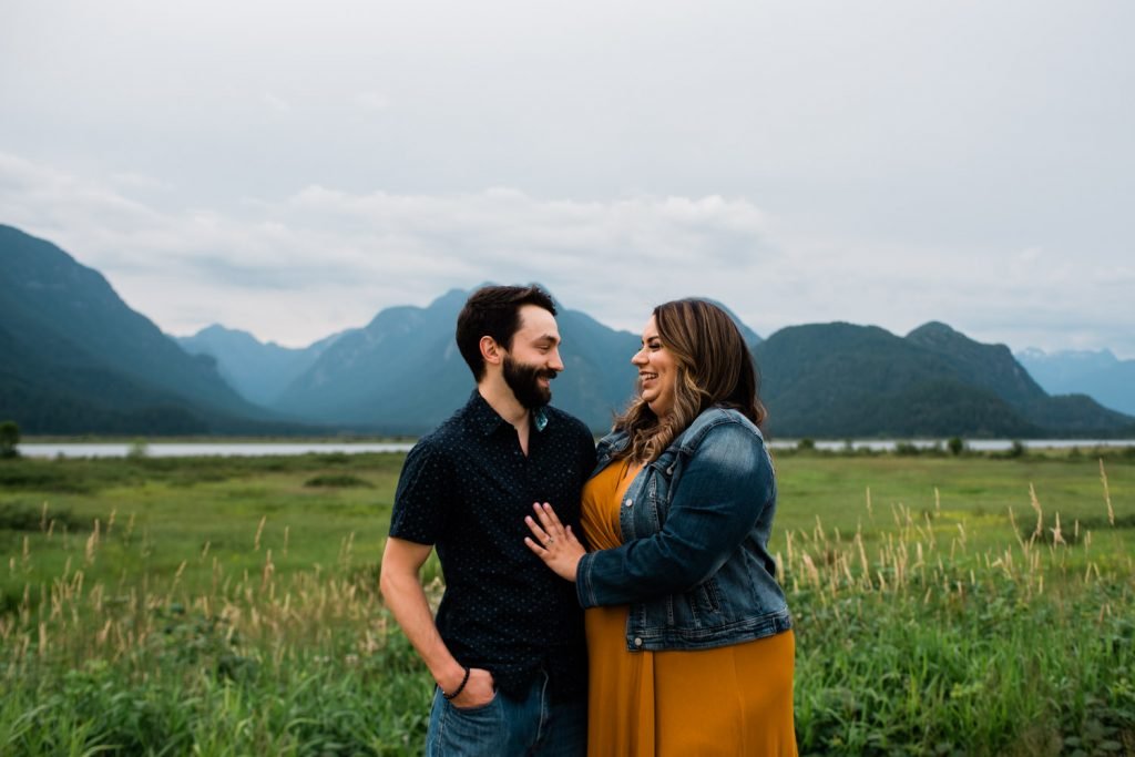 Couple in front of mountains at Pitt Lake