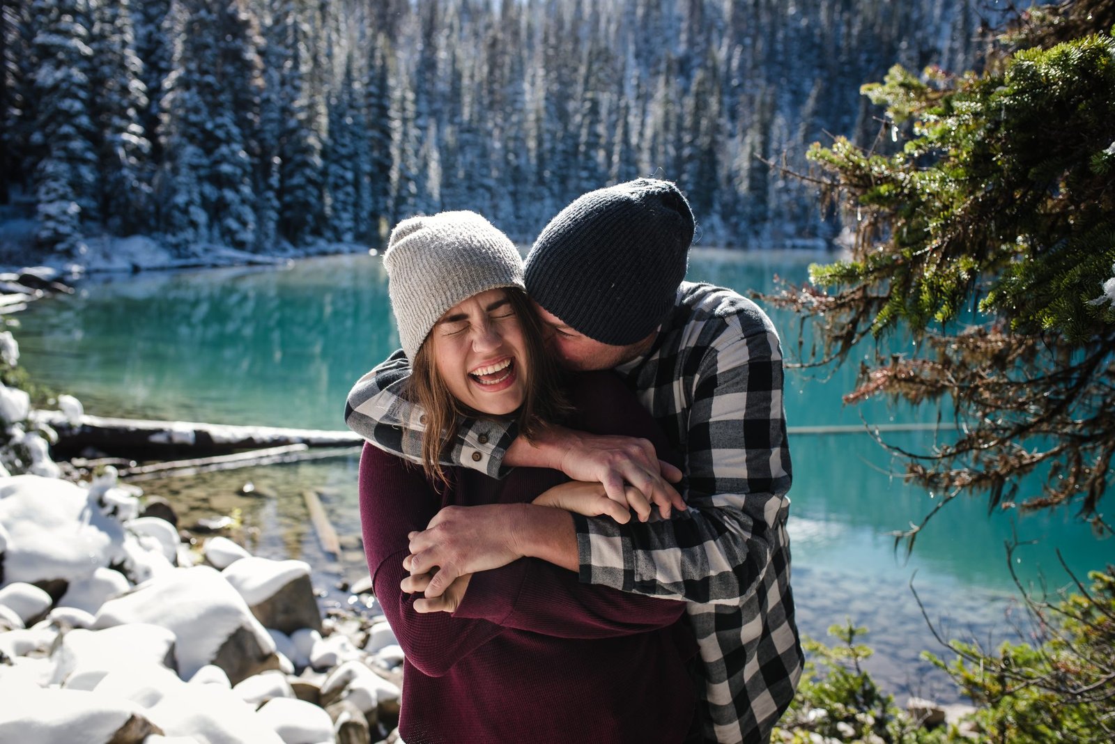 A guy hugs his girl during engagement photos at Joffre Lakes.
