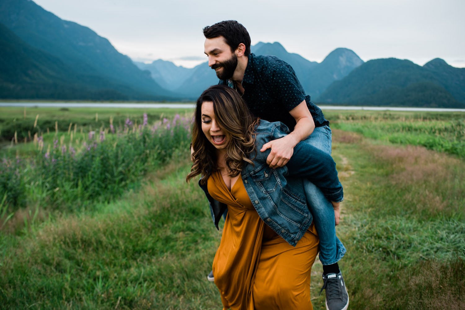 Couple in front of mountains during engagement session at Pitt Lake, BC.